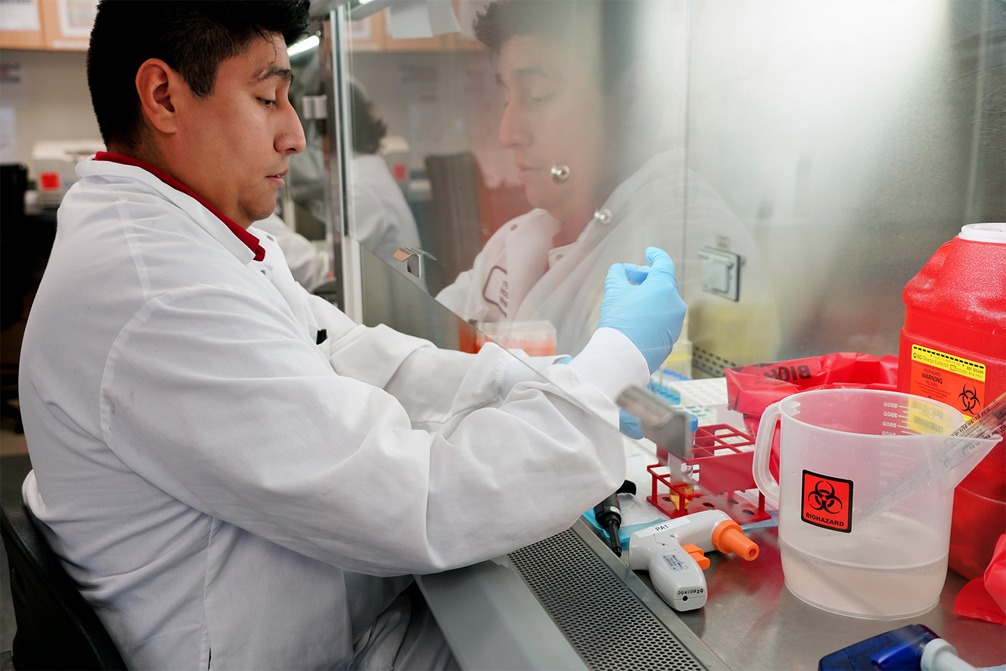 Lab employee working with lab equipment